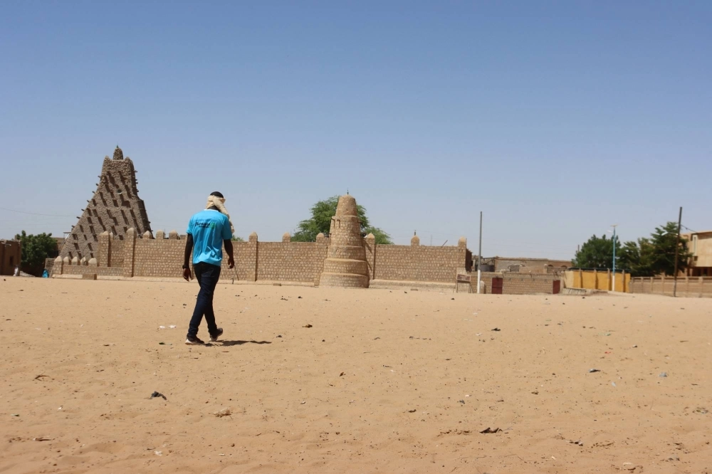 A man walks toward Sankore mosque, also known as the former University of Sankore, in Timbuktu, Mali  A man walks toward Sankore mosque, also known as the former University of Sankore, in Timbuktu, Mali