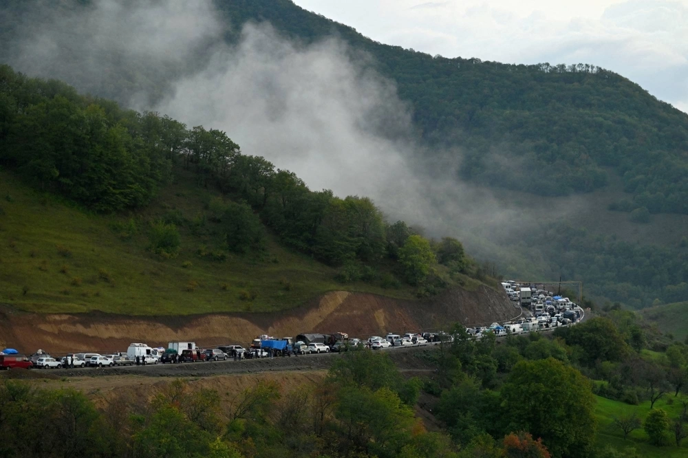 Vehicles carrying refugees from Nagorno-Karabakh, a region inhabited by ethnic Armenians, pack the road leading towards the Armenian border on Sept. 25.  Vehicles carrying refugees from Nagorno-Karabakh, a region inhabited by ethnic Armenians, pack the road leading towards the Armenian border on Sept. 25.
