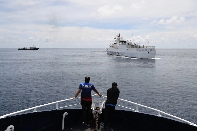Philippine crew monitor a Chinese coast guard ship near the entrance of Chinese-controlled Scarborough Shoal in disputed waters in the South China Sea. Philippine crew monitor a Chinese coast guard ship near the entrance of Chinese-controlled Scarborough Shoal in disputed waters in the South China Sea.