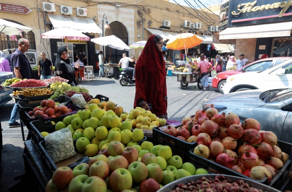 A woman walks past a market in the southern Lebanese city of Sidon. Lebanon is one of nine Arab nations using an algorithm-powered poverty assessment formula funded by the World Bank that ranks welfare applicants according to dozens of different data points. A woman walks past a market in the southern Lebanese city of Sidon. Lebanon is one of nine Arab nations using an algorithm-powered poverty assessment formula funded by the World Bank that ranks welfare applicants according to dozens of different data points.