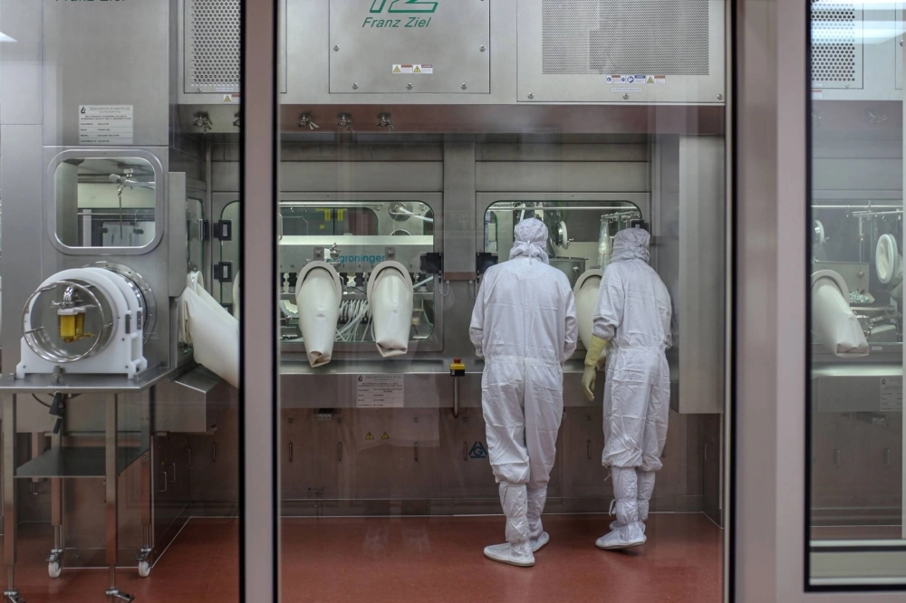 Employees monitor the production of Covishield, the local name for the COVID-19 vaccine developed by AstraZeneca and the University of Oxford, at the Serum Institute of India in Pune, Maharashtra, India. Employees monitor the production of Covishield, the local name for the COVID-19 vaccine developed by AstraZeneca and the University of Oxford, at the Serum Institute of India in Pune, Maharashtra, India.