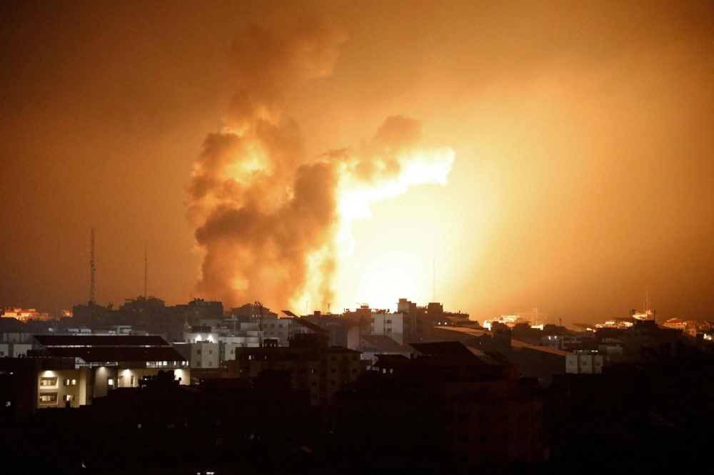Fire and smoke rises above buildings during an Israeli airstrike in Gaza City, in the Gaza Strip, on Sunday.  Fire and smoke rises above buildings during an Israeli airstrike in Gaza City, in the Gaza Strip, on Sunday.