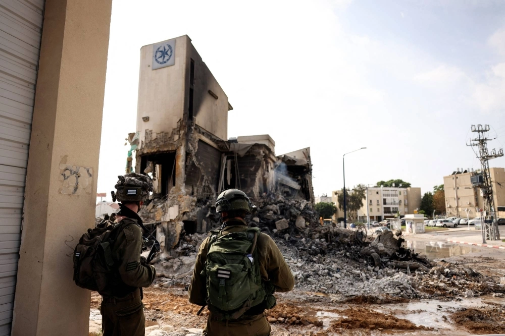 Israeli soldiers examine the remains of a police station where a battle took place following a mass infiltration by Hamas gunmen from the Gaza Strip in Sderot, Israel, on Sunday. Israeli soldiers examine the remains of a police station where a battle took place following a mass infiltration by Hamas gunmen from the Gaza Strip in Sderot, Israel, on Sunday.