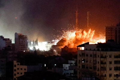 Flames and smoke billow from explosions during Israeli strikes in Gaza on Monday. Flames and smoke billow from explosions during Israeli strikes in Gaza on Monday.