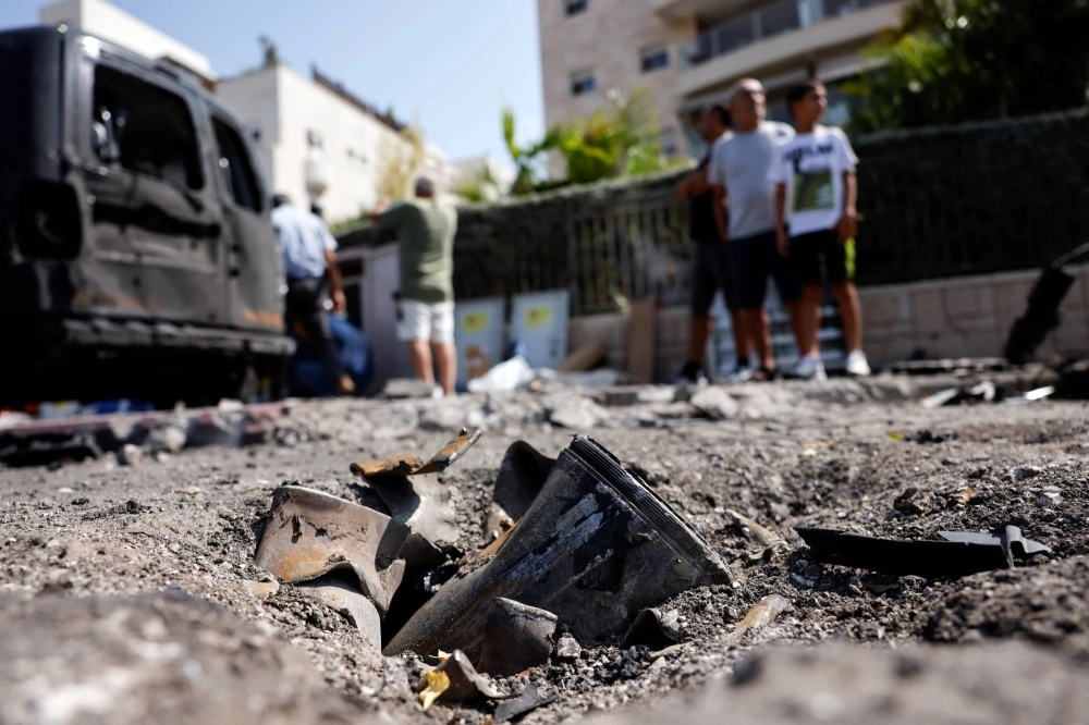 The remains of a rocket fired from the Gaza Strip into Israel lies on a road where it fell in Ashkelon, southern Israel, on Tuesday. The remains of a rocket fired from the Gaza Strip into Israel lies on a road where it fell in Ashkelon, southern Israel, on Tuesday.
