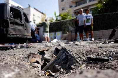 The remains of a rocket fired from the Gaza Strip into Israel lies on a road where it fell in Ashkelon, southern Israel, on Tuesday. The remains of a rocket fired from the Gaza Strip into Israel lies on a road where it fell in Ashkelon, southern Israel, on Tuesday.