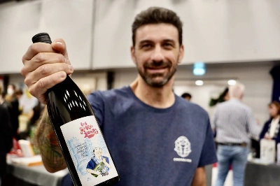 A representative of Chevalier Brewery presents a bottle of its sake adapted to French drinkers' tastes. A representative of Chevalier Brewery presents a bottle of its sake adapted to French drinkers' tastes.