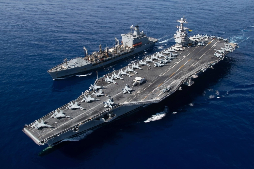 The world's largest aircraft carrier, the USS Gerald R. Ford, sails during a fueling-at-sea operation in the eastern Mediterranean Sea on Wednesday. The world's largest aircraft carrier, the USS Gerald R. Ford, sails during a fueling-at-sea operation in the eastern Mediterranean Sea on Wednesday.