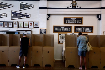 Voters fill out ballot papers at a polling station on Sydney's Bondi Beach on Saturday as polls open in Australia's historic Indigenous rights referendum. Voters fill out ballot papers at a polling station on Sydney's Bondi Beach on Saturday as polls open in Australia's historic Indigenous rights referendum.