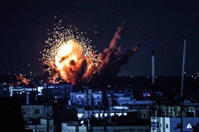 A ball of fire and smoke rises during an Israeli strike on the Gaza Strip on Monday.  A ball of fire and smoke rises during an Israeli strike on the Gaza Strip on Monday.