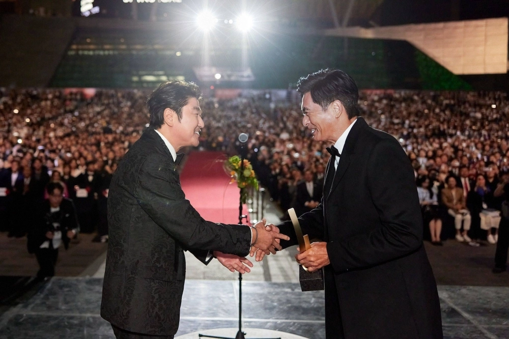 Busan International Film Festival host Song Kang-ho presents the Asian Filmmaker of the Year award to veteran Hong Kong star Chow Yun-fat at the 2023 edition of the Asian film festival. Busan International Film Festival host Song Kang-ho presents the Asian Filmmaker of the Year award to veteran Hong Kong star Chow Yun-fat at the 2023 edition of the Asian film festival.