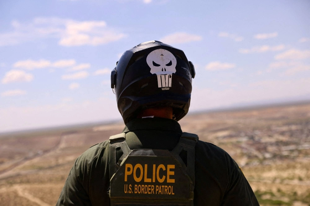 A U.S. Border Patrol agent searches for migrants trying to enter the United States from the Mexico border, in a desert area in Sunland Park, New Mexico. A U.S. Border Patrol agent searches for migrants trying to enter the United States from the Mexico border, in a desert area in Sunland Park, New Mexico.