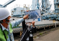 Employees of JERA brief reporters at the utility's Hekinan plant in 2021.  | Reuters