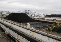 Piles of coal at JERA's Hekinan plant in 2021. Japan aims to lower coal’s share of its energy mix to 19% by 2030, despite calls from the United Nations and environmental organizations for OECD countries to stop all use of coal by then. | Reuters