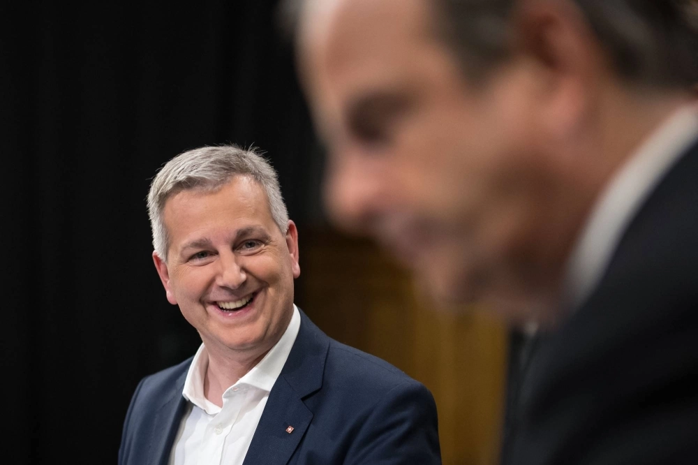 Swiss People's Party (SVP) leader Marco Chiesa (left) smiles next to the president of The Center (Die Mitte) Swiss political party Gerhard Pfister prior to a TV interview in Bern on Sunday. Swiss People's Party (SVP) leader Marco Chiesa (left) smiles next to the president of The Center (Die Mitte) Swiss political party Gerhard Pfister prior to a TV interview in Bern on Sunday.