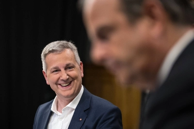 Swiss People's Party (SVP) leader Marco Chiesa (left) smiles next to the president of The Center (Die Mitte) Swiss political party Gerhard Pfister prior to a TV interview in Bern on Sunday. Swiss People's Party (SVP) leader Marco Chiesa (left) smiles next to the president of The Center (Die Mitte) Swiss political party Gerhard Pfister prior to a TV interview in Bern on Sunday.