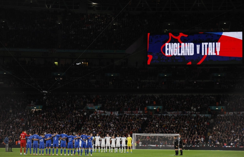 English and Italian footballers observe a minute of silence for the victims of a deadly shooting in Brussels and of the devastating events in Israel and Palestine, at Wembley Stadium in London on Oct. 17. English and Italian footballers observe a minute of silence for the victims of a deadly shooting in Brussels and of the devastating events in Israel and Palestine, at Wembley Stadium in London on Oct. 17.