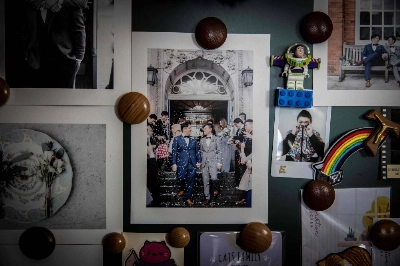 A photo of Henry Li and his husband, Edgar Ng, hangs on a wall in their apartment at Ma On Shan in Hong Kong.  A photo of Henry Li and his husband, Edgar Ng, hangs on a wall in their apartment at Ma On Shan in Hong Kong.