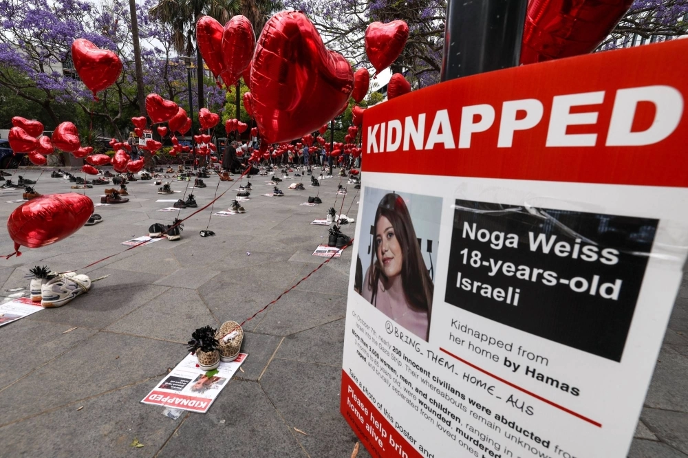 A poster bearing a photo of Israeli hostage Noga Weiss is displayed during a gathering called Balloons of Hope in Sydney on Friday.  A poster bearing a photo of Israeli hostage Noga Weiss is displayed during a gathering called Balloons of Hope in Sydney on Friday.