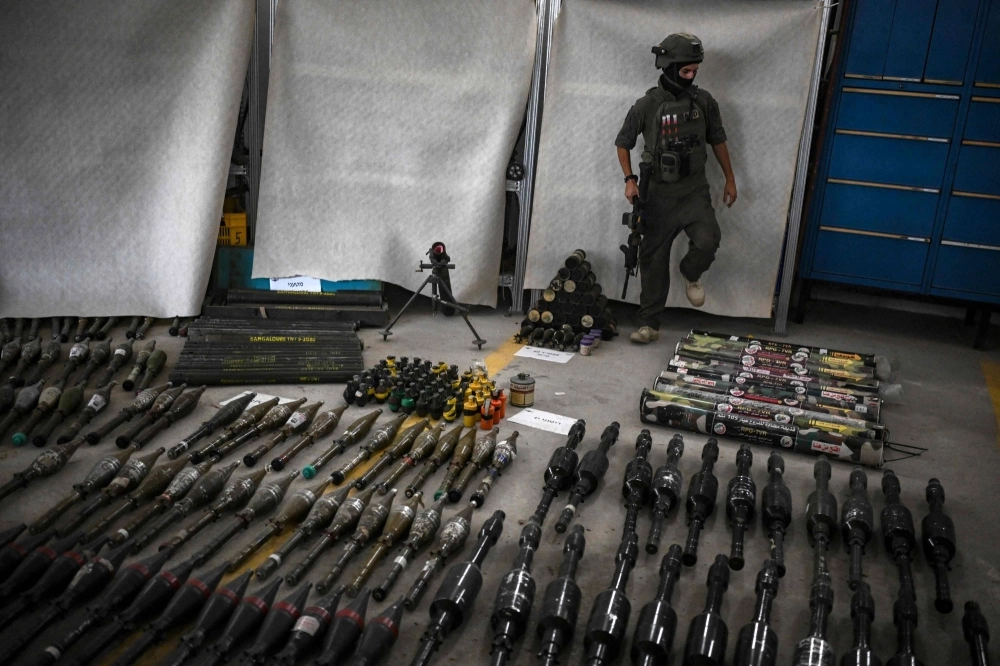 An Israeli soldier stands near armaments Thursday, during an official media tour organized by the military, where they displayed a variety of weapons recovered from areas hit by the Palestinian Hamas militants during their Oct. 7 attack on communities across southern Israel. Israel's military said a portion of the weapons used by Hamas during the attacks were made in Iran and North Korea. An Israeli soldier stands near armaments Thursday, during an official media tour organized by the military, where they displayed a variety of weapons recovered from areas hit by the Palestinian Hamas militants during their Oct. 7 attack on communities across southern Israel. Israel's military said a portion of the weapons used by Hamas during the attacks were made in Iran and North Korea.