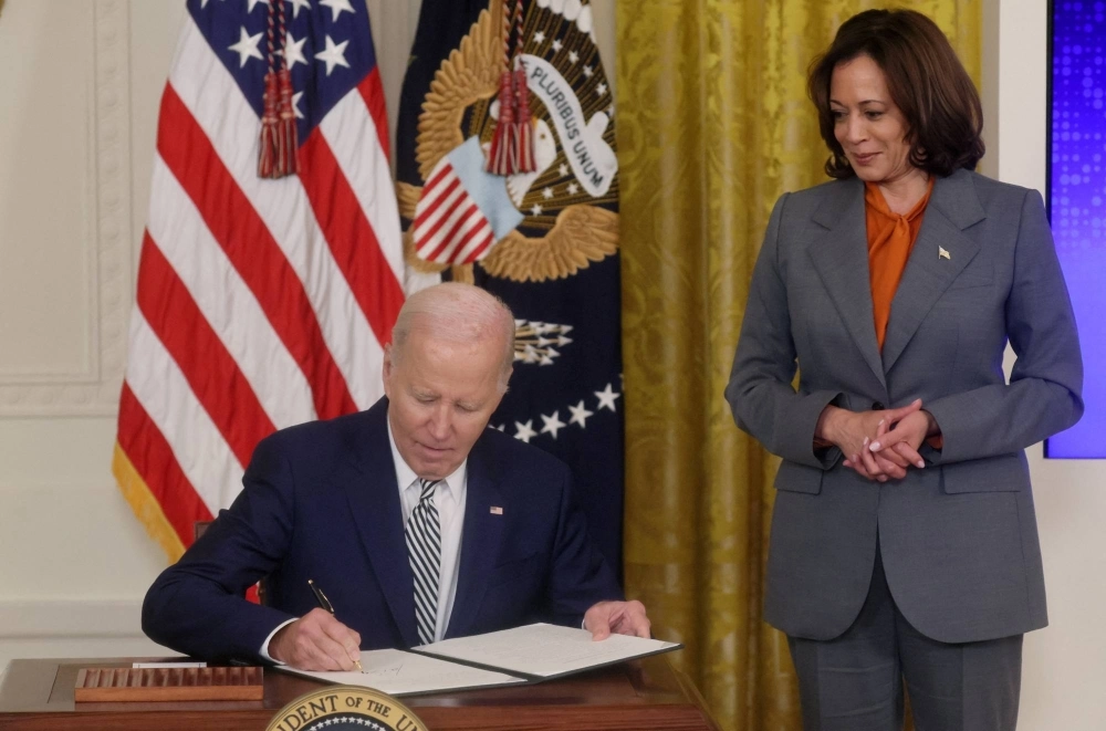 U.S. President Joe Biden signs an Executive Order about Artificial Intelligence as Vice President Kamala Harris looks on, at the White House in Washington on Monday. U.S. President Joe Biden signs an Executive Order about Artificial Intelligence as Vice President Kamala Harris looks on, at the White House in Washington on Monday.