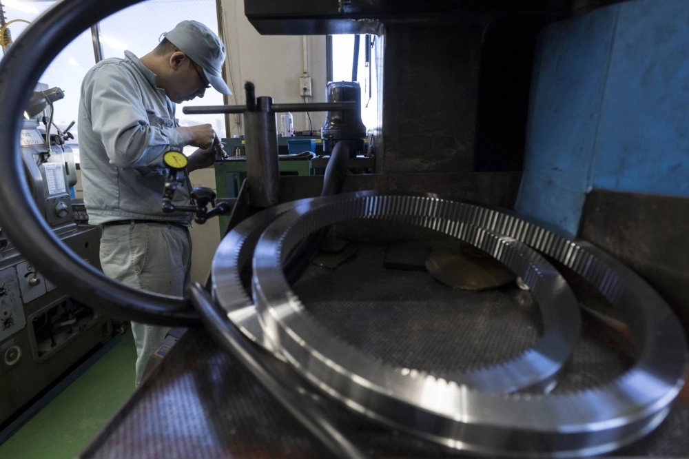An employee works on the production line of the Kohara Gear Industry Co. factory in Kawaguchi, Japan, in 2019.  An employee works on the production line of the Kohara Gear Industry Co. factory in Kawaguchi, Japan, in 2019.