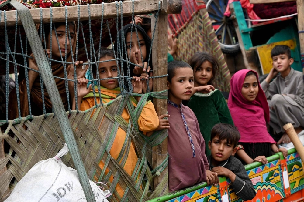 Afghan children refugees arrive on trucks from Pakistan at the Afghanistan-Pakistan Torkham border in Nangarhar province on Wednesday. Islamabad issued an ultimatum in early October to 1.7 million Afghans it says were living illegally in Pakistan to leave by Nov.1 or face arrest and expulsion. Afghan children refugees arrive on trucks from Pakistan at the Afghanistan-Pakistan Torkham border in Nangarhar province on Wednesday. Islamabad issued an ultimatum in early October to 1.7 million Afghans it says were living illegally in Pakistan to leave by Nov.1 or face arrest and expulsion.