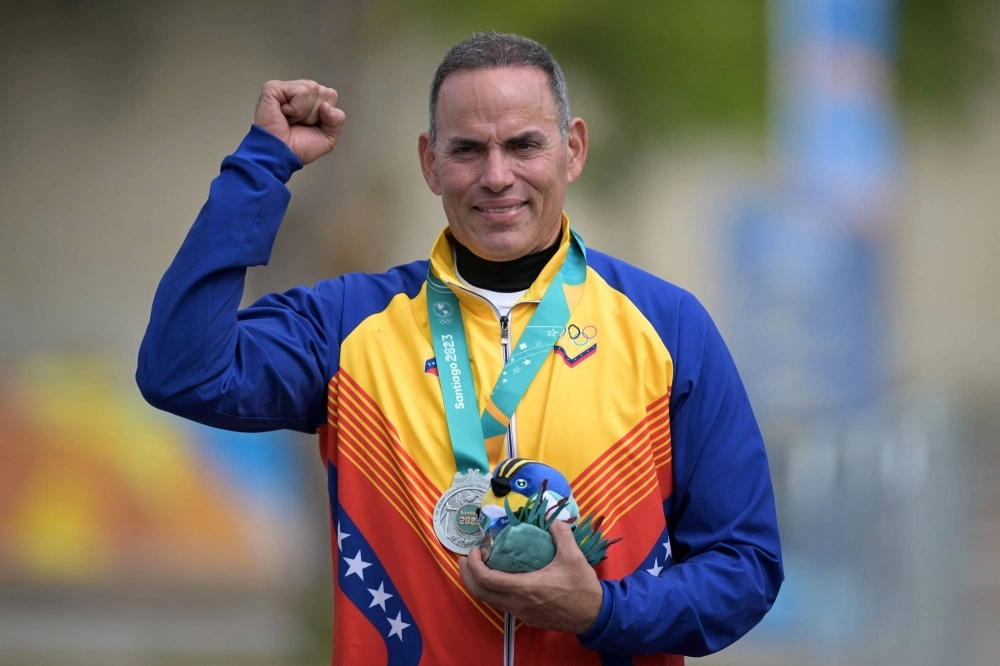 Venezuela's Leonel Martinez poses on the podium with his silver medal after the men's trap final shooting event at the Pan American Games in Santiago on Oct. 27.  Venezuela's Leonel Martinez poses on the podium with his silver medal after the men's trap final shooting event at the Pan American Games in Santiago on Oct. 27.