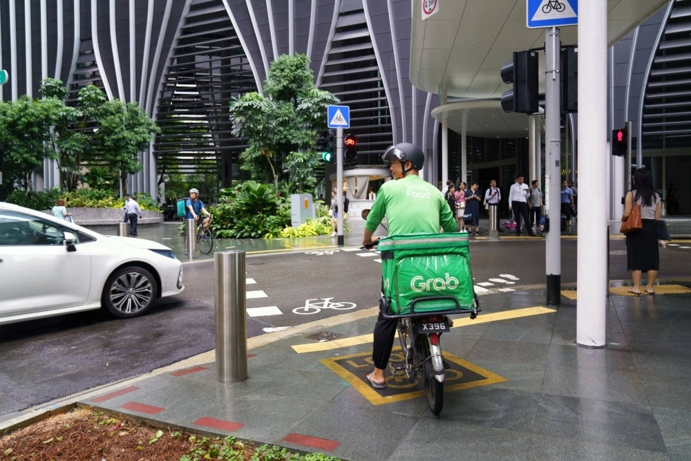 A Grab food delivery cyclist makes a delivery in Singapore on Aug. 21. A Grab food delivery cyclist makes a delivery in Singapore on Aug. 21.