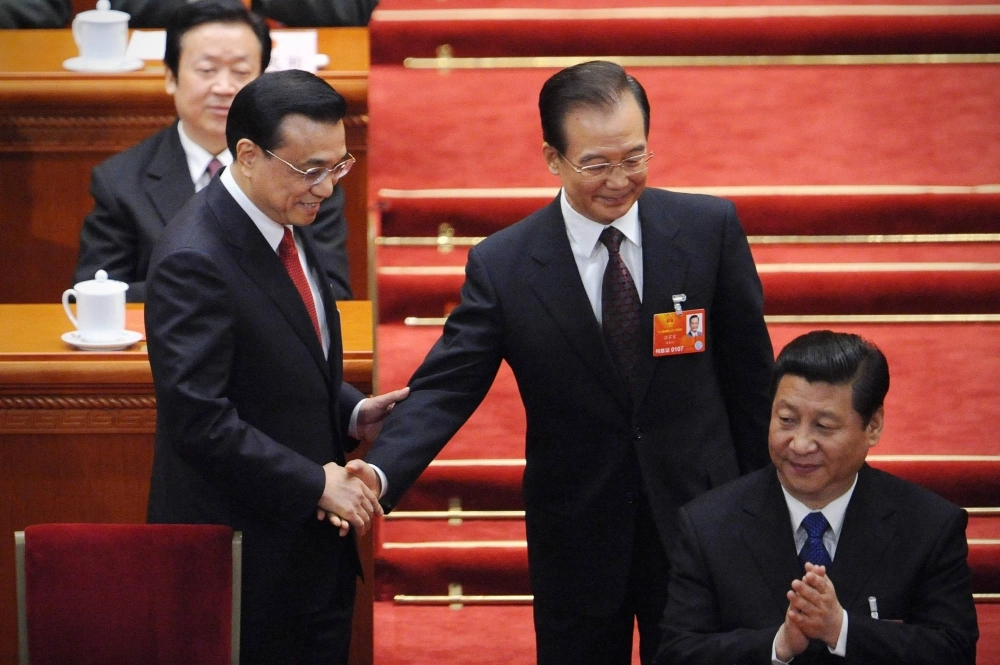 New Chinese Premier Li Keqiang (left) and and his predecessor, Wen Jiabao (center), attend the 12th National People's Congress where Chinese President Xi Jinping was first elected in Beijing in March 2013. New Chinese Premier Li Keqiang (left) and and his predecessor, Wen Jiabao (center), attend the 12th National People's Congress where Chinese President Xi Jinping was first elected in Beijing in March 2013.