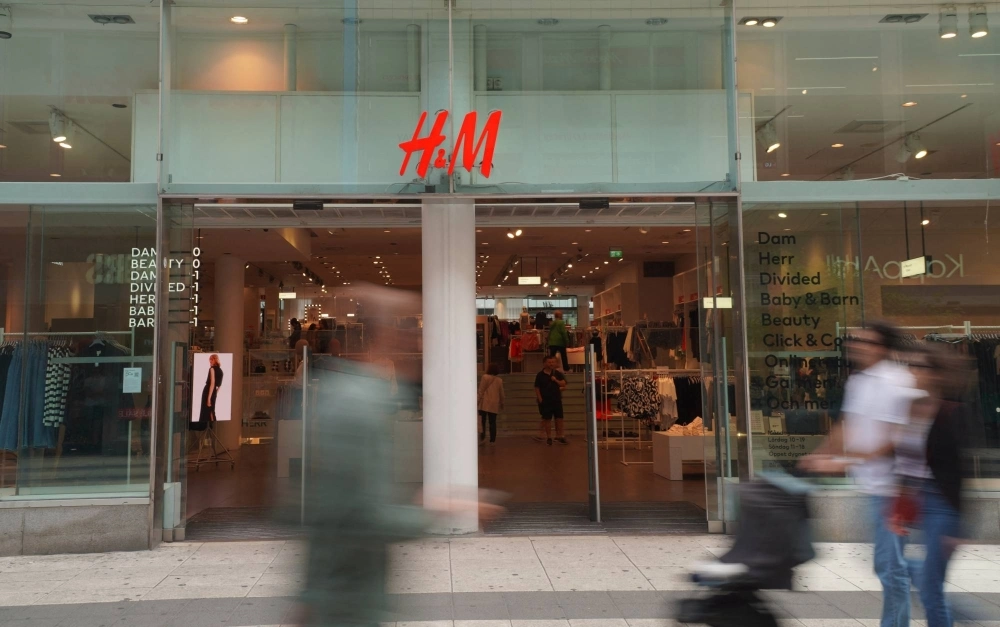 Pedestrians and shoppers walk past a branch of fashion retailer H&M in central Stockholm on July 17. Pedestrians and shoppers walk past a branch of fashion retailer H&M in central Stockholm on July 17.