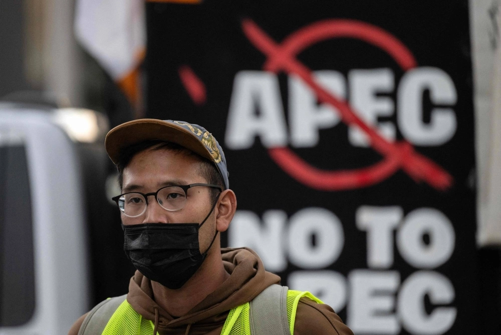 A protester looks on during a protest on the sidelines of the Asia-Pacific Economic Cooperation Leaders' Meeting in San Francisco on Sunday. A protester looks on during a protest on the sidelines of the Asia-Pacific Economic Cooperation Leaders' Meeting in San Francisco on Sunday.