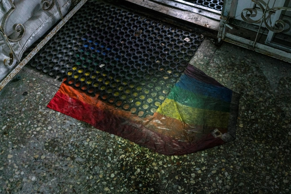 An pride flag is seen under a rubber door mat at an entrance to a basement of an office building in Kherson, Ukraine, in 2022.  An pride flag is seen under a rubber door mat at an entrance to a basement of an office building in Kherson, Ukraine, in 2022.