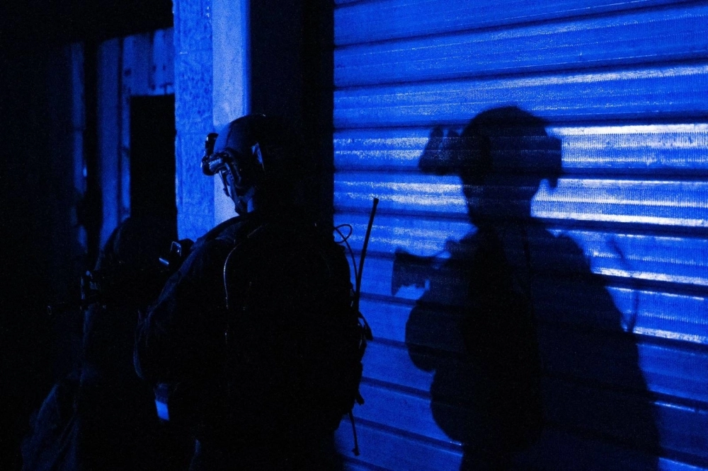 Soldiers during a military operation around at Shifa hospital in Gaza City. Israeli forces raided Gaza's largest hospital on Wednesday, targeting what they say is a Hamas command center in tunnels beneath thousands of patients and civilians seeking refuge from intense combat. Soldiers during a military operation around at Shifa hospital in Gaza City. Israeli forces raided Gaza's largest hospital on Wednesday, targeting what they say is a Hamas command center in tunnels beneath thousands of patients and civilians seeking refuge from intense combat.