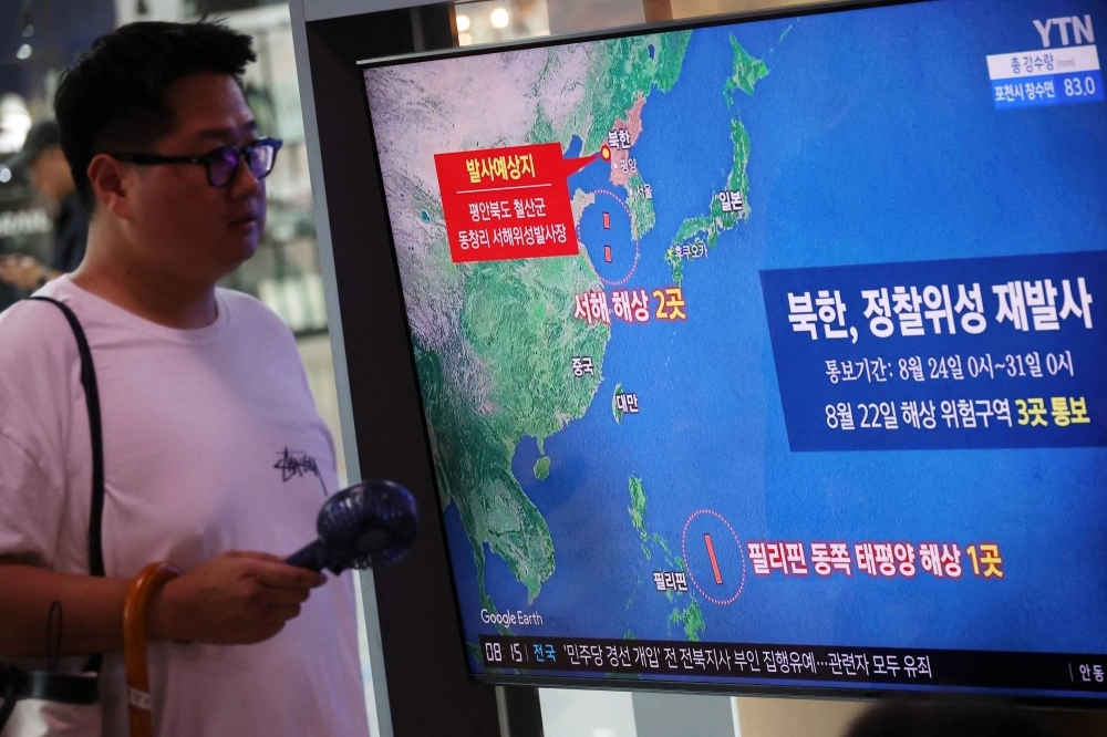 A man walks past a TV broadcasting a news report on North Korea firing a space rocket, at the main railway station in Seoul in August. A man walks past a TV broadcasting a news report on North Korea firing a space rocket, at the main railway station in Seoul in August.