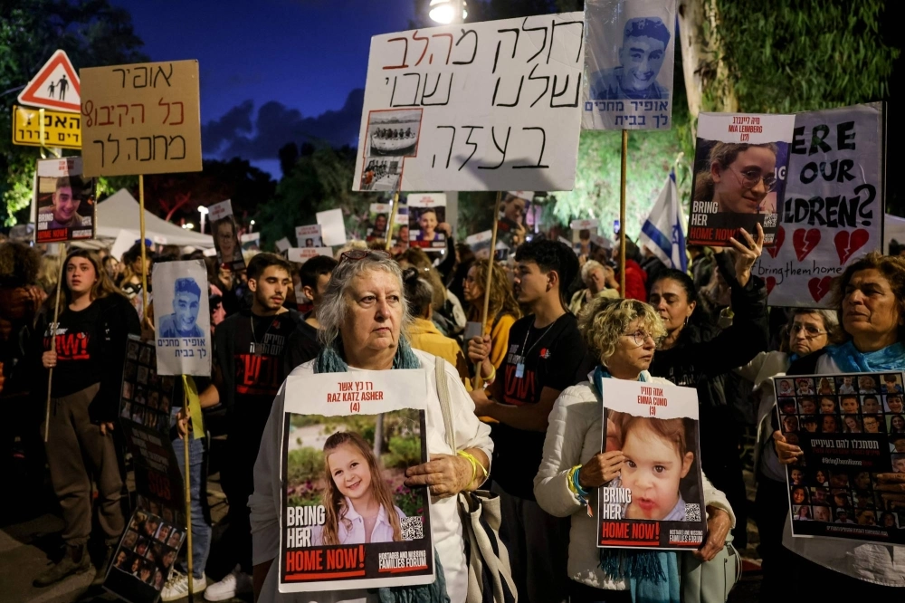 Protesters hold portraits of hostages during a rally outside the UNICEF offices in Tel Aviv on Monday to demand the release of Israelis captured by Hamas in its surprise Oct. 7 attack. Protesters hold portraits of hostages during a rally outside the UNICEF offices in Tel Aviv on Monday to demand the release of Israelis captured by Hamas in its surprise Oct. 7 attack.