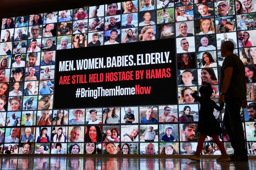 Portraits of Israeli hostages held in Gaza since the Oct. 7 attack by Hamas militants, in Tel Aviv on Tuesday. Portraits of Israeli hostages held in Gaza since the Oct. 7 attack by Hamas militants, in Tel Aviv on Tuesday.