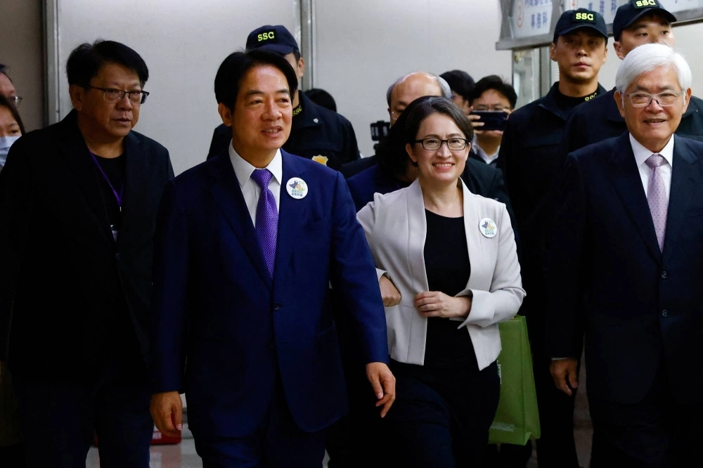 Taiwan's Vice President Lai Ching-te and his running mate Hsiao Bi-Khim arrive to register for the upcoming presidential election for the ruling Democratic Progressive Party (DPP) at the Central Election Commission in Taipei, on Tuesday.  Taiwan's Vice President Lai Ching-te and his running mate Hsiao Bi-Khim arrive to register for the upcoming presidential election for the ruling Democratic Progressive Party (DPP) at the Central Election Commission in Taipei, on Tuesday.