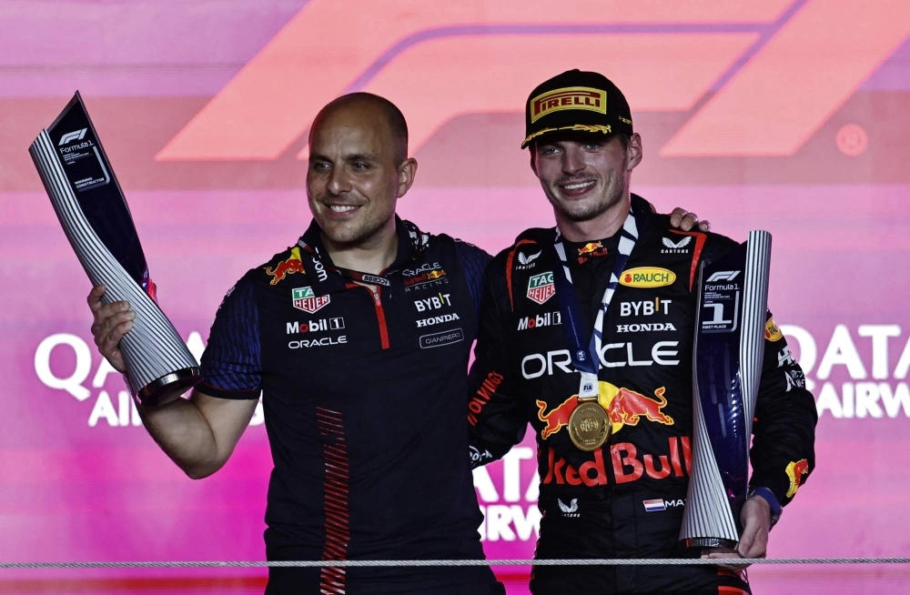 Red Bull driver Max Verstappen (right) celebrates with engineer Gianpiero Lambiase after winning the Qatar Grand Prix in Lusail, Qatar, on Oct. 8. Red Bull driver Max Verstappen (right) celebrates with engineer Gianpiero Lambiase after winning the Qatar Grand Prix in Lusail, Qatar, on Oct. 8.