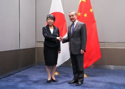 Foreign Minister Yoko Kamikawa shakes hands with her Chinese counterpart, Wang Yi, during bilateral talks in Busan, South Korea, on Saturday evening. Foreign Minister Yoko Kamikawa shakes hands with her Chinese counterpart, Wang Yi, during bilateral talks in Busan, South Korea, on Saturday evening.