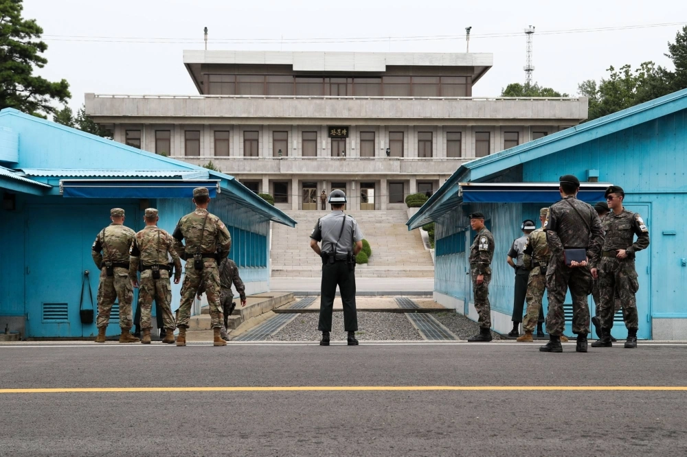 South Korean and U.S. soldiers stand guard next to the United Nations Command Military Armistice Commission building on the South Korean side of the Demilitarized Zone at Panmunjom in July 2017. South Korean and U.S. soldiers stand guard next to the United Nations Command Military Armistice Commission building on the South Korean side of the Demilitarized Zone at Panmunjom in July 2017.