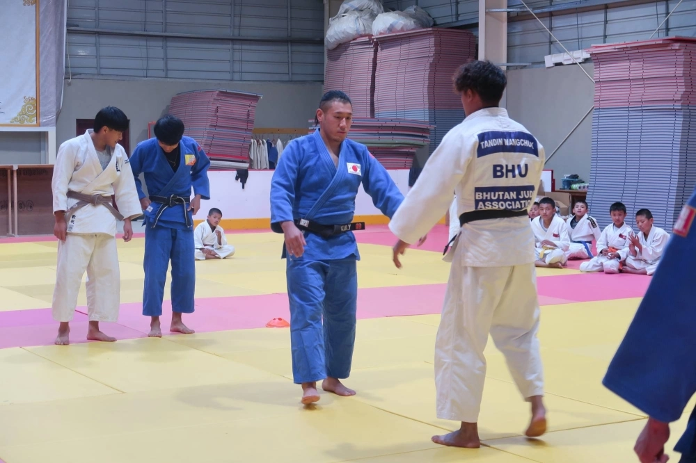Yuki Fukui (center) squares up against a student during a training session at a judo dojo in Thimphu, Bhutan. Yuki Fukui (center) squares up against a student during a training session at a judo dojo in Thimphu, Bhutan.