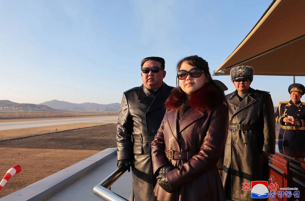 North Korean leader Kim Jong Un and his daughter observe an air festival during a visit with the 1st Air Force Division Flying Regiment of the Korean People's Army to commemorate Air Day, at an unknown location on Thursday. North Korean leader Kim Jong Un and his daughter observe an air festival during a visit with the 1st Air Force Division Flying Regiment of the Korean People's Army to commemorate Air Day, at an unknown location on Thursday.