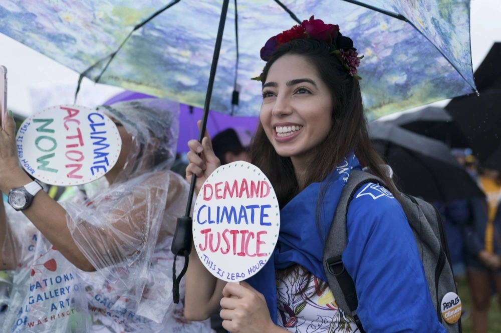 Demonstrators call for action on climate change and environmental justice during a march in Washington in July 2018. Demonstrators call for action on climate change and environmental justice during a march in Washington in July 2018.