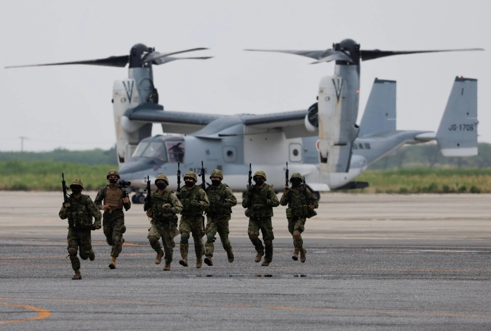 Ground Self-Defense Force personnel take part in a military drill involving a V-22 Osprey aircraft in June 2022.  Ground Self-Defense Force personnel take part in a military drill involving a V-22 Osprey aircraft in June 2022.