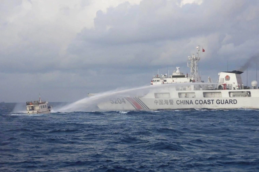 A China Coast Guard vessel uses a water cannon against a Philippine supply boat as it carries out a mission to deliver provisions to the Second Thomas Shoal in the disputed South China Sea on Sunday. A China Coast Guard vessel uses a water cannon against a Philippine supply boat as it carries out a mission to deliver provisions to the Second Thomas Shoal in the disputed South China Sea on Sunday.