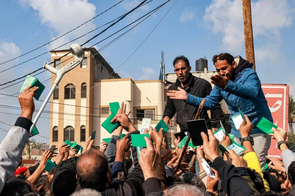 Palestinians gather to receive food rations for their families outside a United Nations warehouse in Rafah, Gaza, on Tuesday. Palestinians gather to receive food rations for their families outside a United Nations warehouse in Rafah, Gaza, on Tuesday.