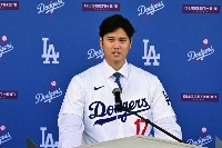 Baseball player Shohei Ohtani speaks during a news conference on his presentation after signing a 10-year deal with the Los Angeles Dodgers at Dodgers Stadium in Los Angeles, California, on Thursday. | AFP-Jiji