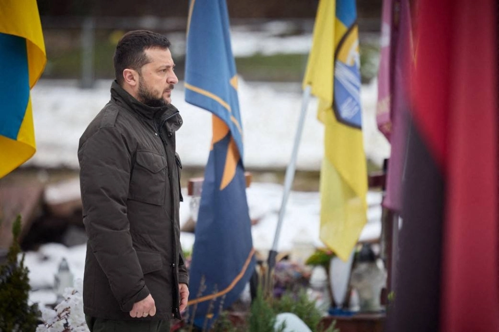 Ukrainian President Volodymyr Zelenskyy pays his respects at the graves of Ukrainian soldiers in Lviv on Friday.  Ukrainian President Volodymyr Zelenskyy pays his respects at the graves of Ukrainian soldiers in Lviv on Friday.