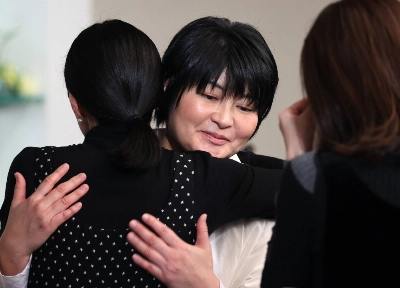 Nobuko, younger sister of Kotaro Nishizawa, who died at his clinic in Osaka during an arson attack, hugs one of the audience members following a memorial concert for the victims held in the city on Dec. 3. Nobuko, younger sister of Kotaro Nishizawa, who died at his clinic in Osaka during an arson attack, hugs one of the audience members following a memorial concert for the victims held in the city on Dec. 3.
